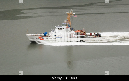 US Coast Guard cruiser leaving port on patrol Stock Photo