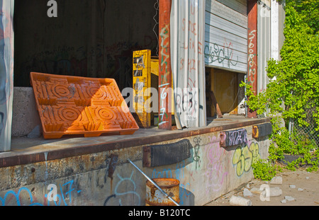 wide open dock on an abandoned factory building sprayed with graffiti Stock Photo