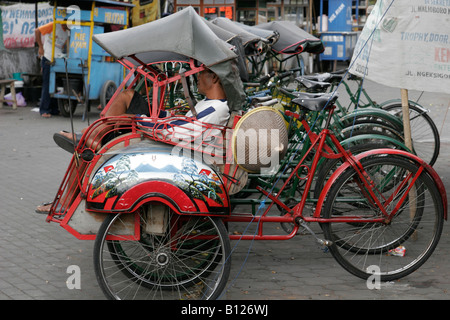 A Traditional Becak (Cycle Rickshaw) and Driver, Malioboro Street ...