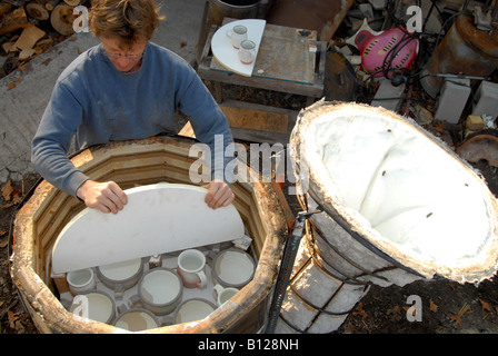 A ceramic firing kiln being loaded in preparation for firing Stock Photo