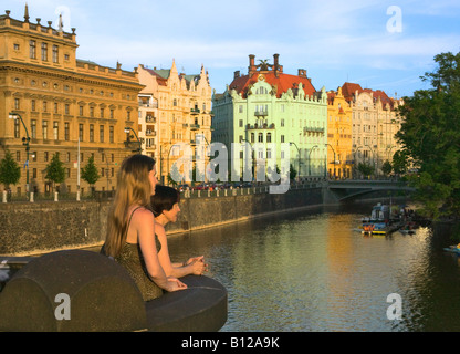 Tourists looking at historical buildings by Vltava River Prague Czech Republic Stock Photo