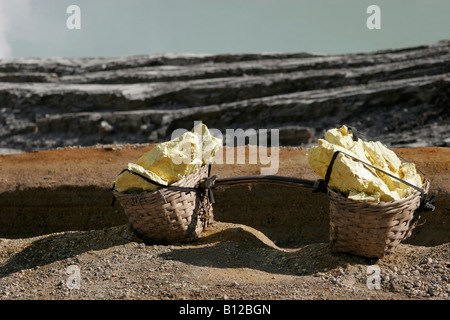 Baskets with sulphur near the lake in the crator of the active volcano, Ijen plateau, East Java, Indonesia, South East Asia Stock Photo