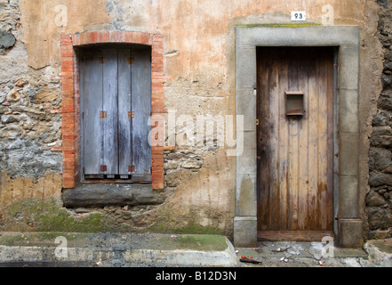 A French Mediterranean old wooden door and window shuttering typical of Southern France Stock Photo