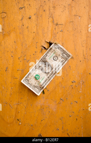 Dollar bill stuck to the door of a bathroom destroyed by a tornado in Aurora, Nebraska, USA. Stock Photo