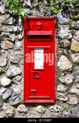 Red Victorian post box on stone wall, Wimborne Minster, Dorset, England, United Kingdom Stock Photo