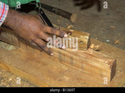 Closeup of Indian carpenter using a wooden plane, Kumarakom, Kerala India Stock Photo