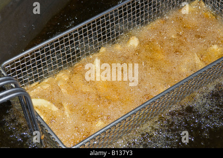 Chips in Deep Fat Fryer Stock Photo