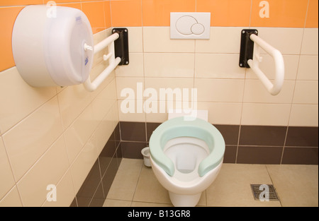 Close up of the inside of a public disabled toilet with dual flush buttons Stock Photo