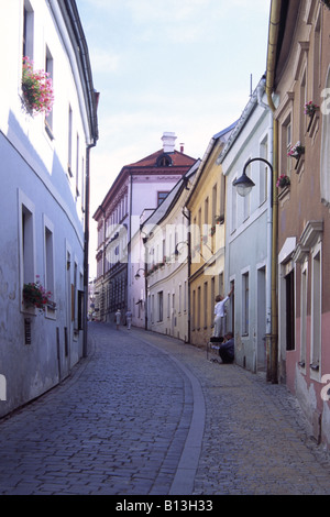 Colouful buildings and daily life in a cobbled shady street of the Old Town, Tabor, Southern Bohemia, Czech Republic Stock Photo