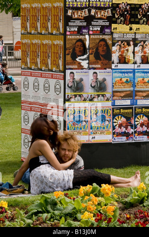 couple lying on the old steine lawns, outside the uderbelly Stock Photo