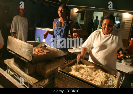 a local chef cook up a fish fry at the Oistins fish market in Bridgetown, Barbados Stock Photo