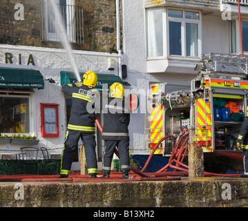 Firemen putting out building fire, St Ives, Cornwall, England Stock Photo