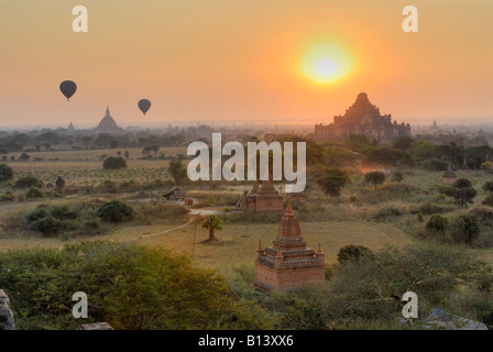 sunrise over Bagan many Pagodas in front and two hot air balloons, BAGAN PAGAN, MYANMAR BURMA BIRMA, ASIA Stock Photo