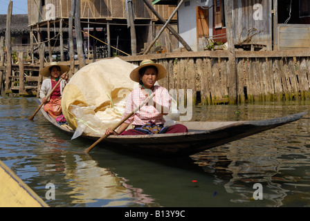 two women in loaded rowing boat on lake, Inle lake, MYANMAR BURMA BIRMA, ASIA Stock Photo
