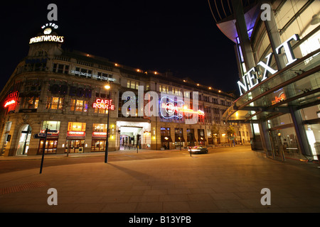 City of Manchester, England. Night view of the Next retail store and Printworks entertainment and leisure complex. Stock Photo