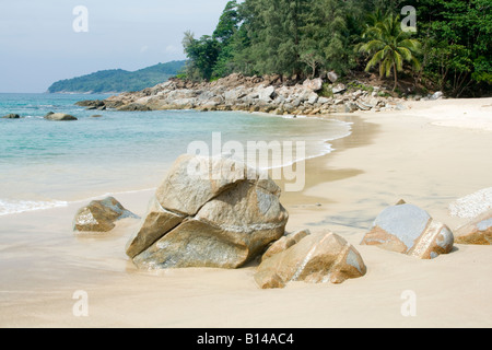 Rocks bordering a beach and sea Stock Photo