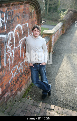 Sulky male hanging around in a park Stock Photo