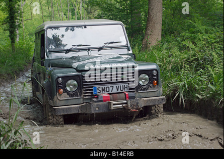 Land Rover Defender 90 TD4 competing at the ALRC National 2008 RTV Trial is driving through flooded forest road. Stock Photo