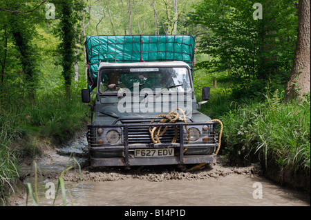 Land Rover Defender 110 Pick-Up support vehicle the ALRC National 2008 RTV Trial driving through flooded forest road. Stock Photo