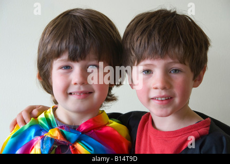 Two young friends wearing rainbow coloured clothing for fancy dress up play Stock Photo