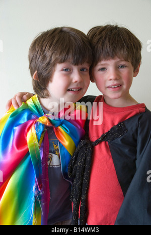 Two young friends wearing rainbow coloured clothing for fancy dress up play Stock Photo
