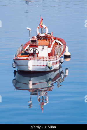 Boat and its reflection on water. Finisterre. La Coruña province. Galicia. Spain. Stock Photo