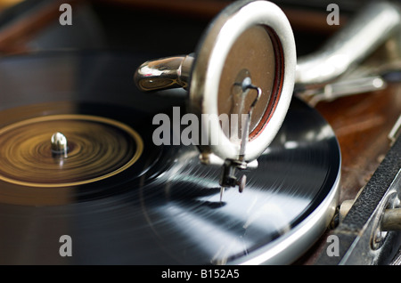 A portable gramophone playing a record Stock Photo
