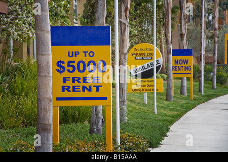 Free Rent signs at a newly built office residential complex in Orange California reflect a depressed real estate market Stock Photo