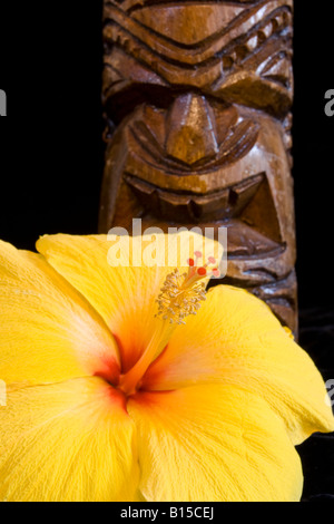 A Hawaiian tiki and a yellow sun hibiscus