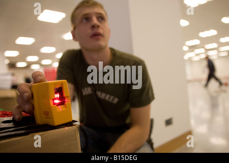 A workman checks a fitting with a laser level. Stock Photo