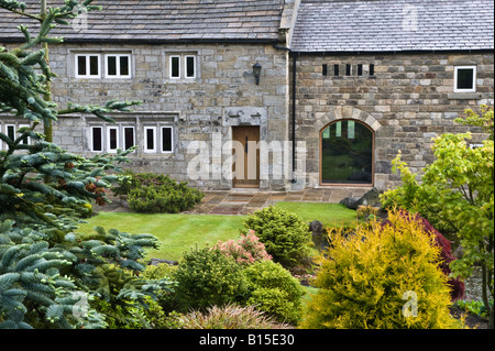 Late 17th century Farmhouse build of local gridstone. On front garden design by Bahaa Seedhom North Yorkshire England May 2008 Stock Photo