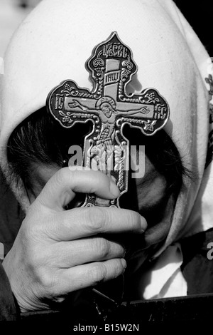 A Greek Orthodox Chrisitan pilgrim waits for an annual mass-Baptism ceremony in the River Jordan Stock Photo