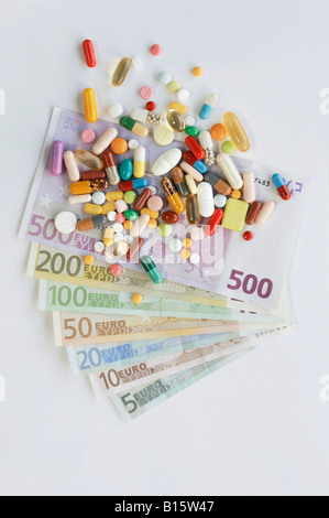 Pills and tablets on top of banknotes Stock Photo