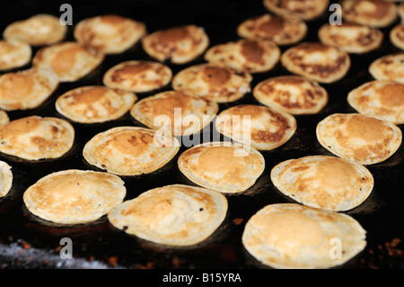 Traditional Dutch Poffertjes, poffertje, small, fluffy mini, baby pancakes  made in cast iron poffertjes pan Stock Photo - Alamy