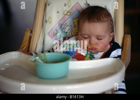 Baby sleeping during feedin g Stock Photo