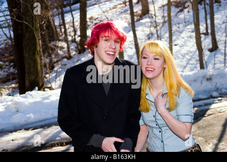 Teen boy with dyed red hair joking around outside with his blond girlfriend Model Released Stock Photo