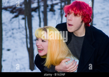 Teen boy with dyed red hair joking around outside with his blond girlfriend Model Released Stock Photo