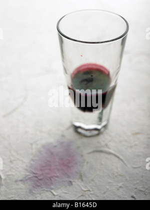 red wine stain and glass on table cloth Stock Photo