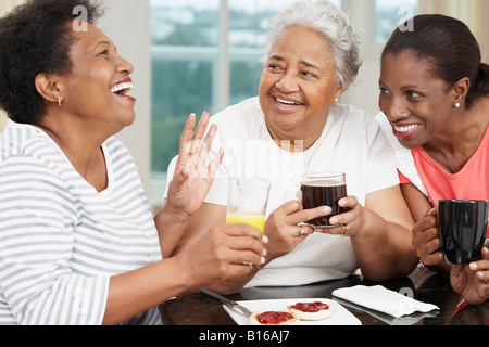African American mother and adult daughters at breakfast Stock Photo