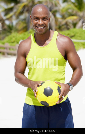 African American man holding soccer ball Stock Photo