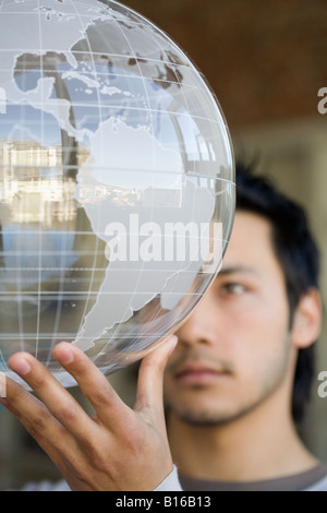 Asian man holding globe Stock Photo