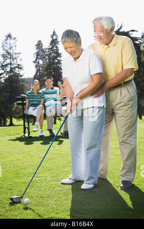 Senior Asian couple playing golf Stock Photo