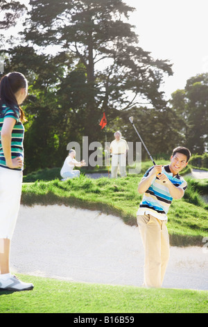 Asian couple playing golf Stock Photo