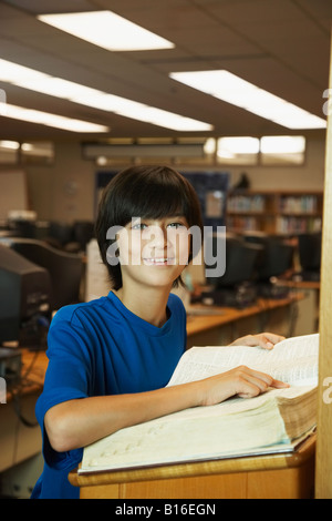 Asian boy using library dictionary Stock Photo
