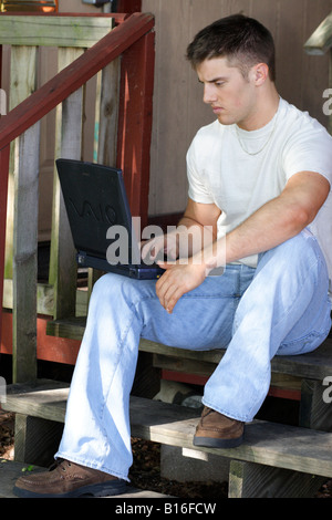 Stock photograph of a young man using a notebook computer Stock Photo