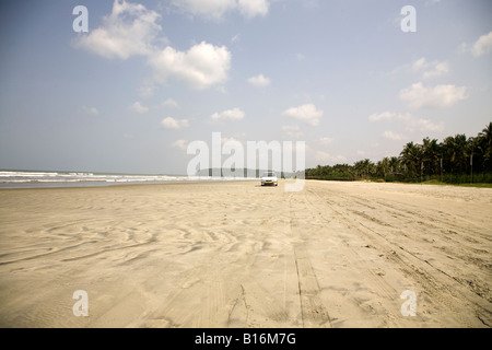 A car drives on Muzhappilangad Drive In Beach near to Thalassery in Kerala. It is India's only drive in beach. Stock Photo