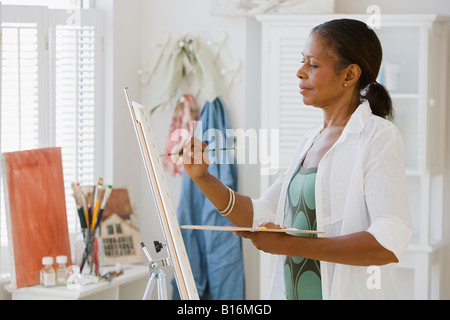 Senior African American woman painting Stock Photo