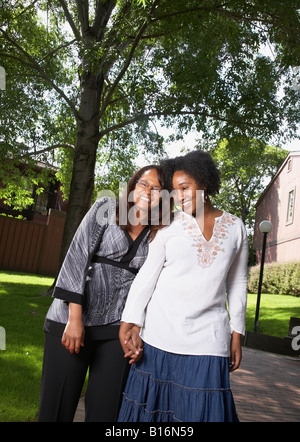 African mother and daughter holding hands and smiling Stock Photo - Alamy
