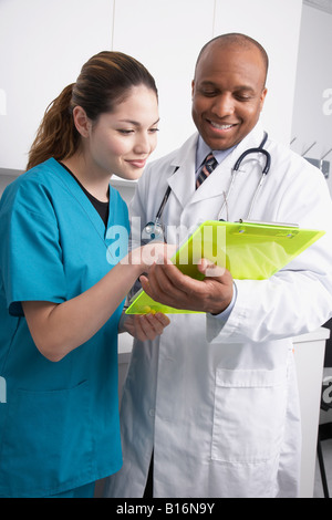 Multi-ethnic medical professionals discussing chart Stock Photo