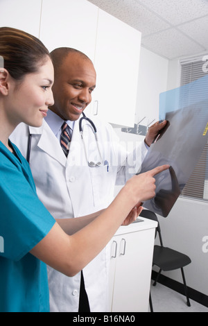 Multi-ethnic medical professionals looking at x-rays Stock Photo
